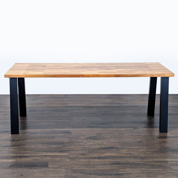 1. Ikea dining table with a walnut veneer top and black legs, shown from the front on a wood floor.