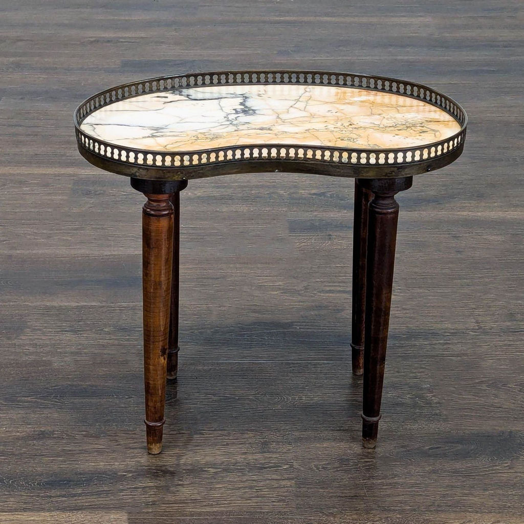 1. Kidney-shaped marble side table with dark wooden legs and brass gallery, shown on a wooden floor.