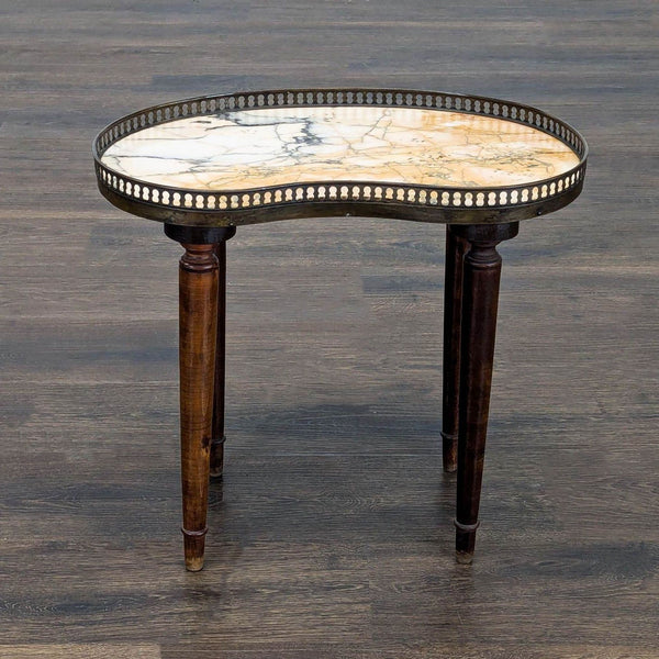 1. Kidney-shaped marble side table with dark wooden legs and brass gallery, shown on a wooden floor.