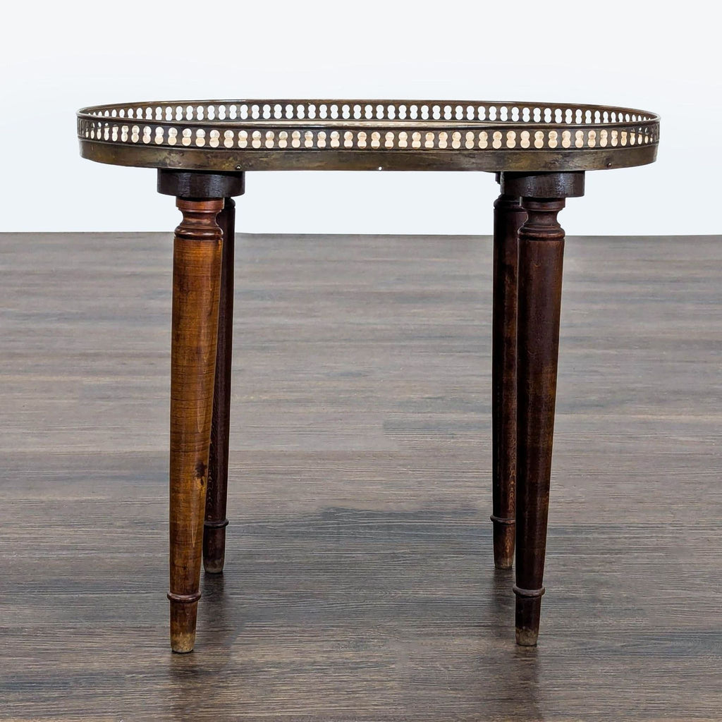 2. Side table with a unique marble top, brass edge, and three tapered wooden legs, category: Side & Console Table.