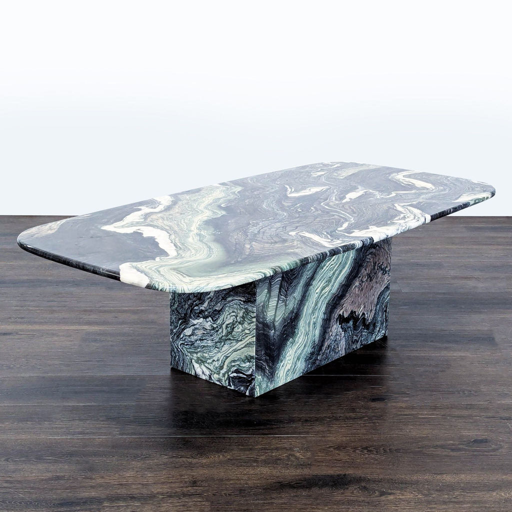2. Modern coffee table features abstract marbled design with rounded edges and a thick rectangular central support.