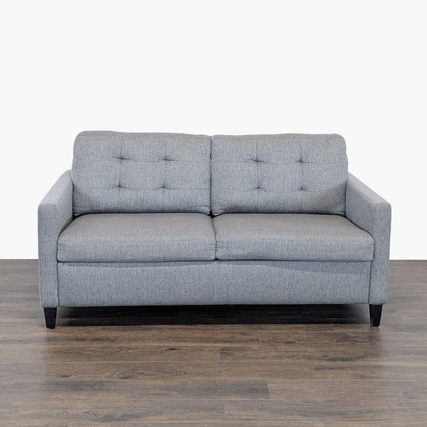 Modern gray Crate and Barrel sleeper sofa with tufted back, easily converts to a bed for guests.
