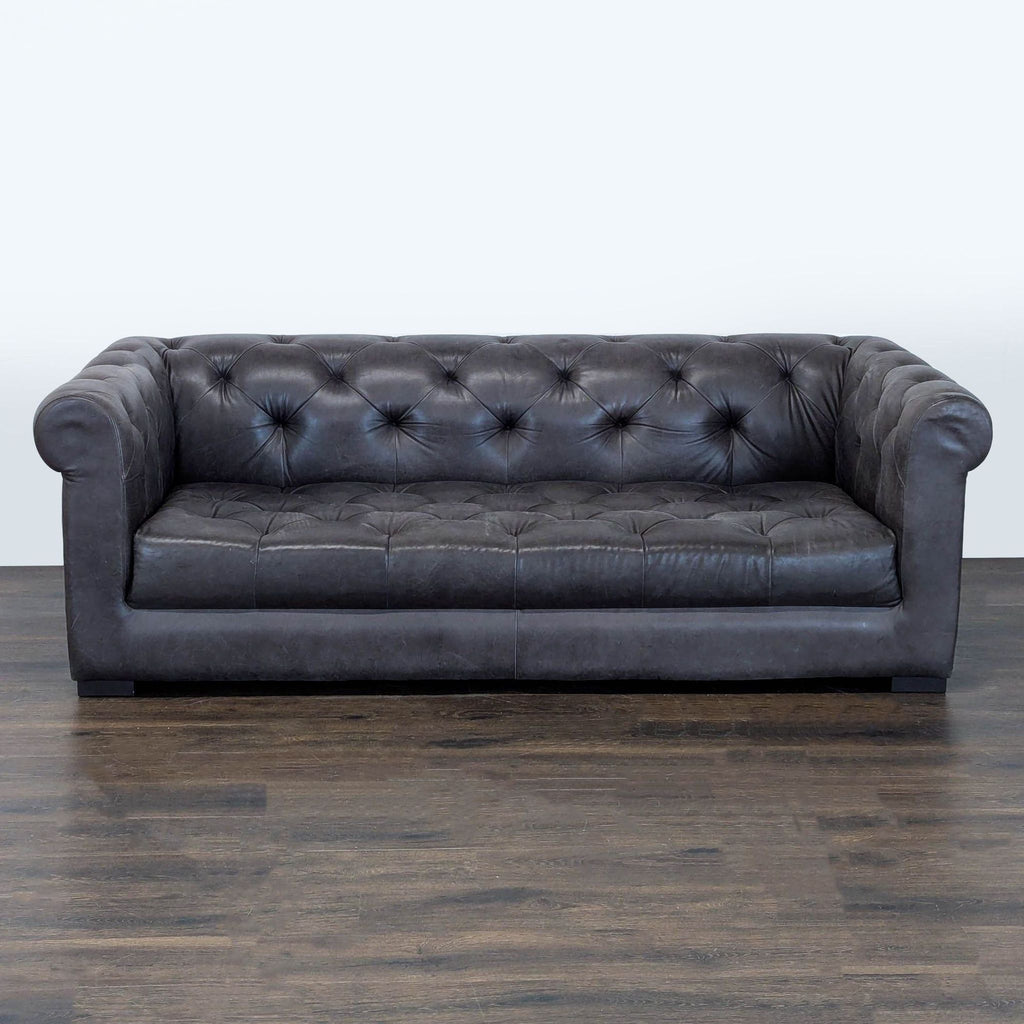 Restoration Hardware brown leather sofa with tufted back, rolled arms, and deep, cushioned seating.