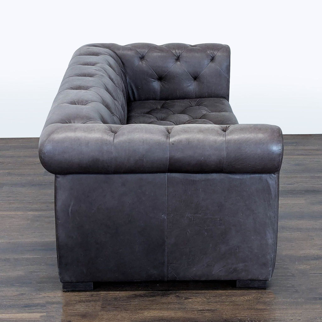Brown leather 3-seat sofa by Restoration Hardware, featuring deep seats, rolled arms, and tufted upholstery.