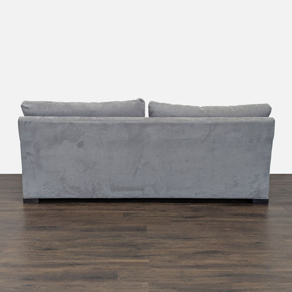 Three-seat Crate and Barrel sofa in gray fabric with a sturdy frame, cushioned seats, and a contemporary look.