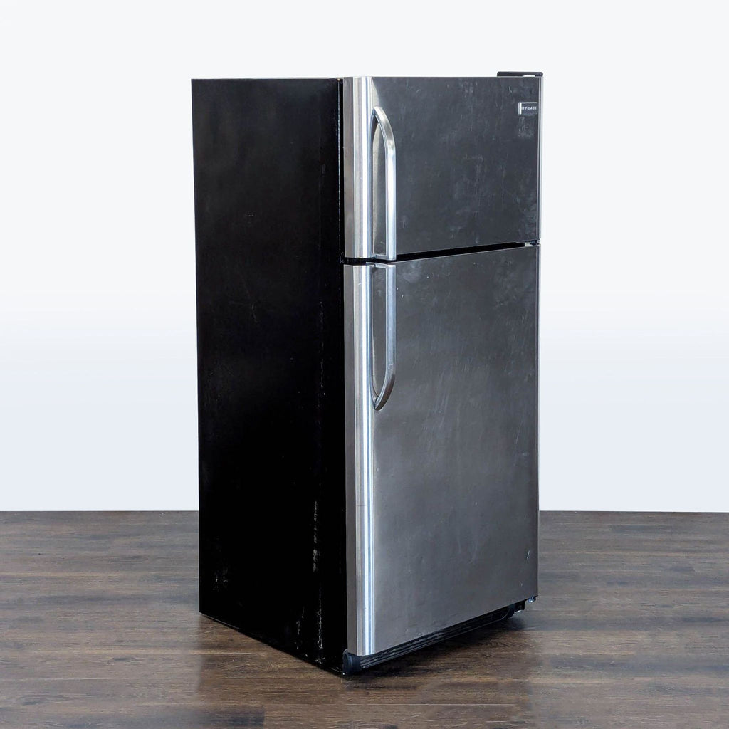 Classic Frigidaire refrigerator featuring a top freezer, roomy door bins, and sleek stainless finish.