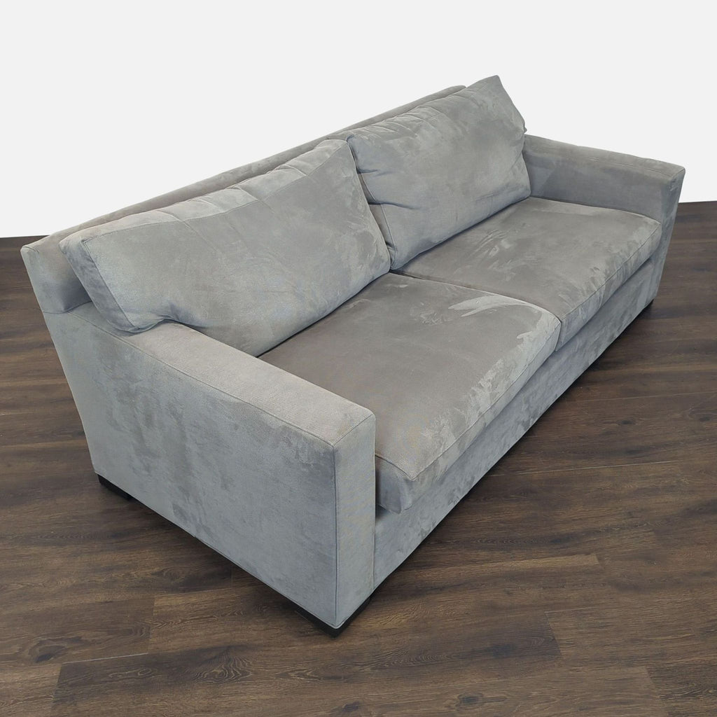 Modern Crate and Barrel sofa in soft gray fabric, featuring thick seat cushions and ample seating for three.