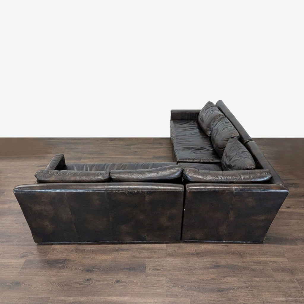 Comfy Restoration Hardware sectional in durable leather, ideal for living rooms due to its roomy L-shape design.