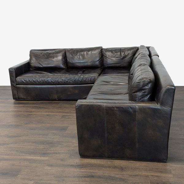 Restoration Hardware L-shaped sectional with deep brown leather and plush cushions for spacious seating.