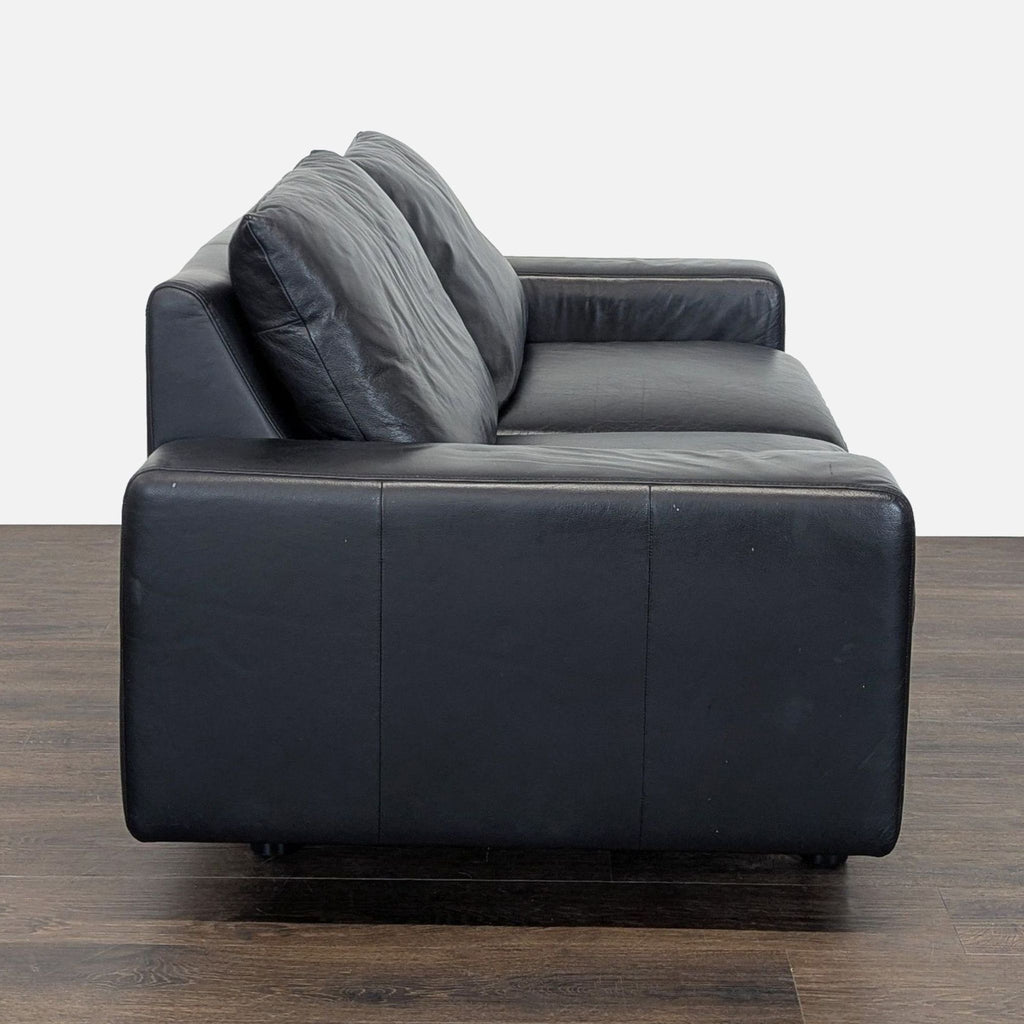 Sleek Ekornes Stressless loveseat in black leather, featuring a compact, stylish look ideal for small living spaces.
