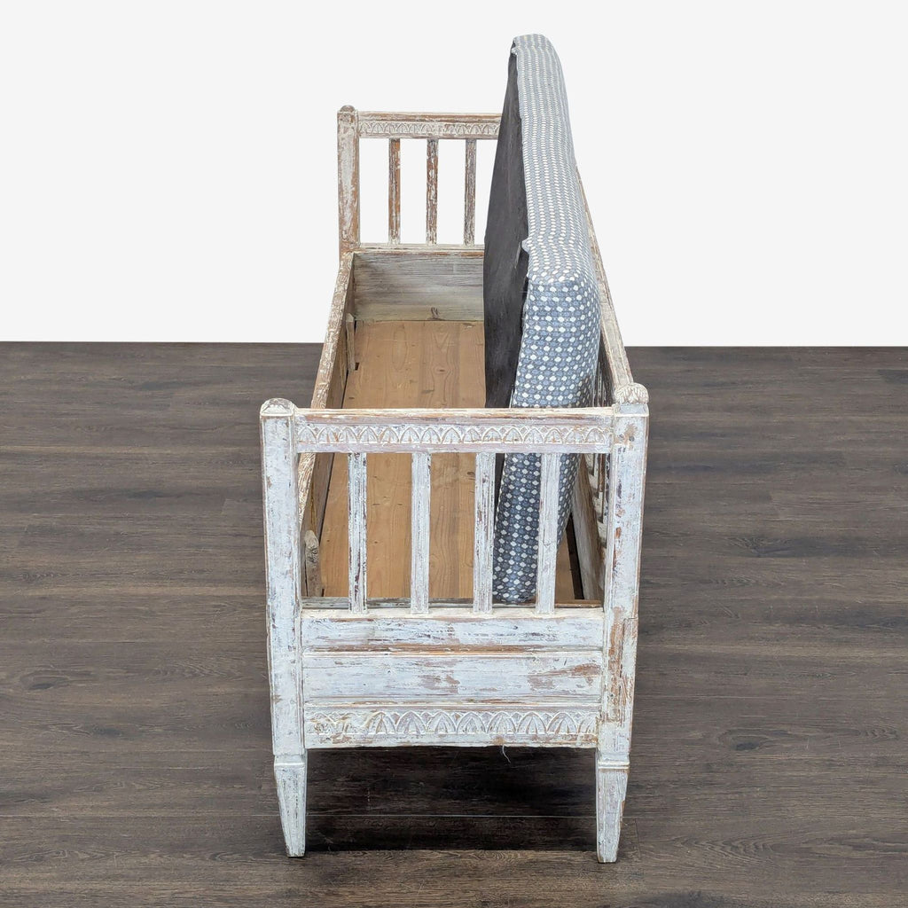 Distressed finish bench, hand-carved for a rustic look, suitable for seating or decor.  