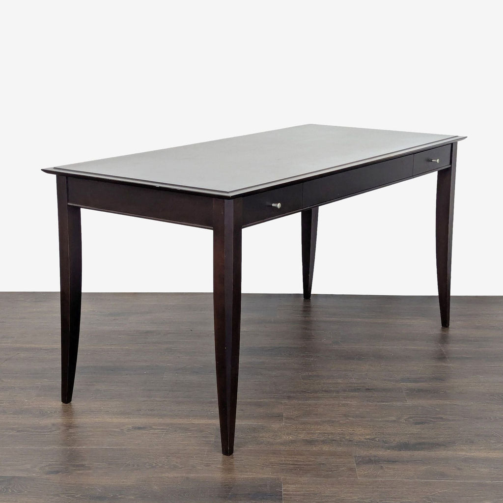 Sturdy Baronet desk featuring clean lines, two storage drawers, and a stylish dark wood look.