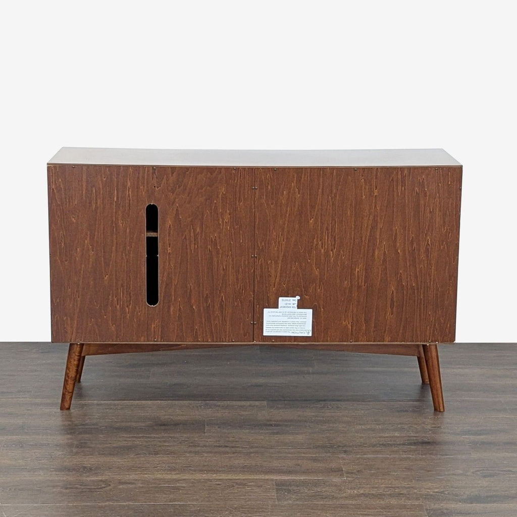 Mid-century style Walker Edison TV stand with middle drawers and side shelves hidden behind cabinet doors.