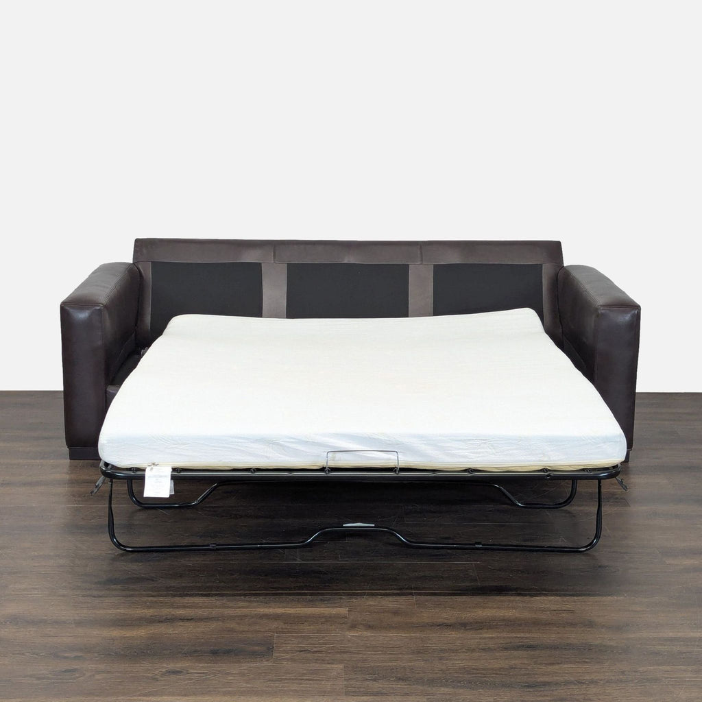 Sleeper sofa by Room and Board in deep brown leather, comfortably seats three and easily converts to a bed.