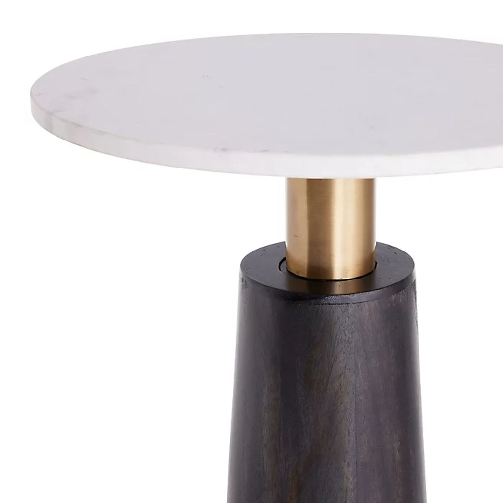 Cylindrical accent table featuring marble, dark wood, and brass base; ideal for contemporary interiors.  