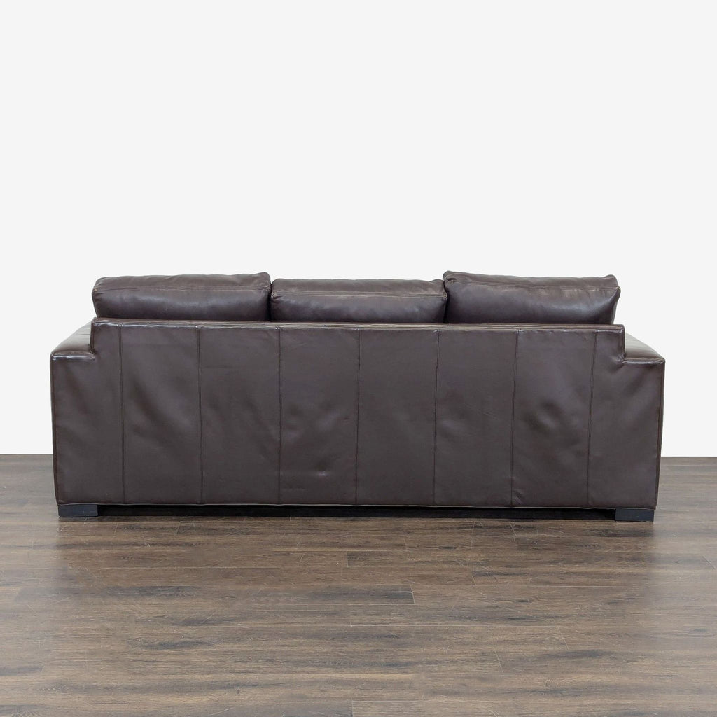 Modern sleeper sofa by Room & Board, upholstered in rich brown leather, ideal for living rooms or guest rooms.