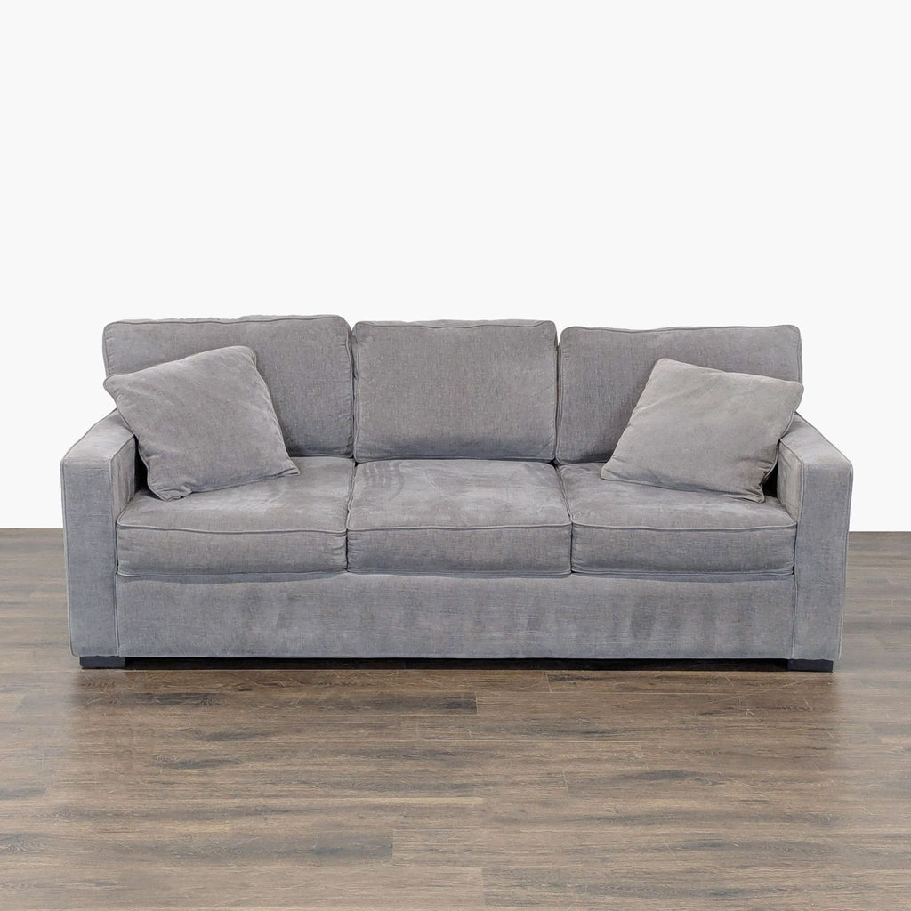 Jonathan Louis gray sleeper sofa with boxy, modern design and two matching pillows, ideal for living rooms.