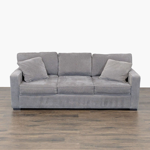 Jonathan Louis gray sleeper sofa with boxy, modern design and two matching pillows, ideal for living rooms.