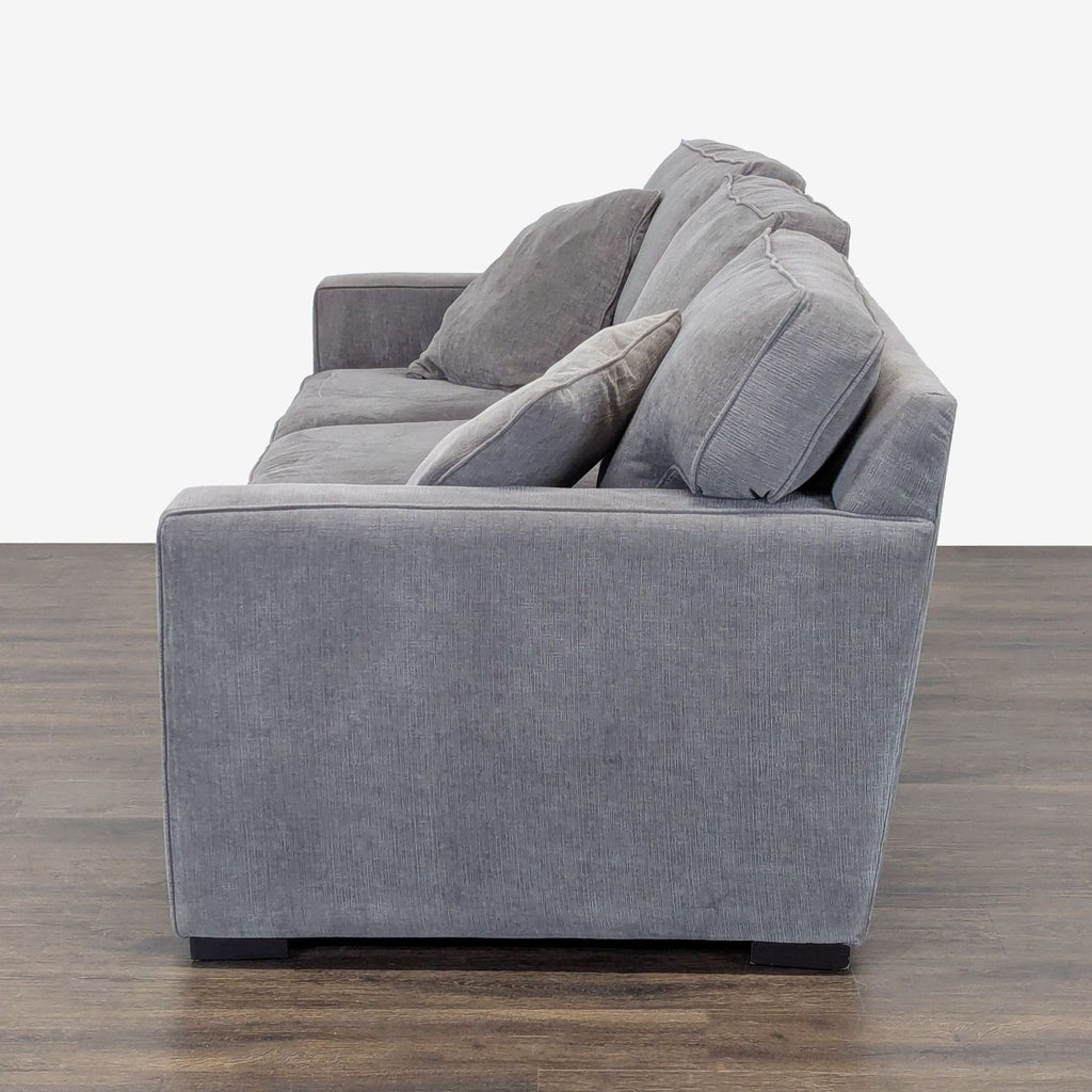 Modern gray sleeper sofa by Jonathan Louis, featuring sturdy build, plush seating, and two matching pillows.