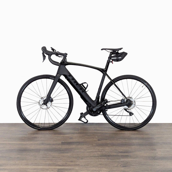 Trek carbon road bike with disc brakes and saddle bag, ideal for performance cycling and long rides.
