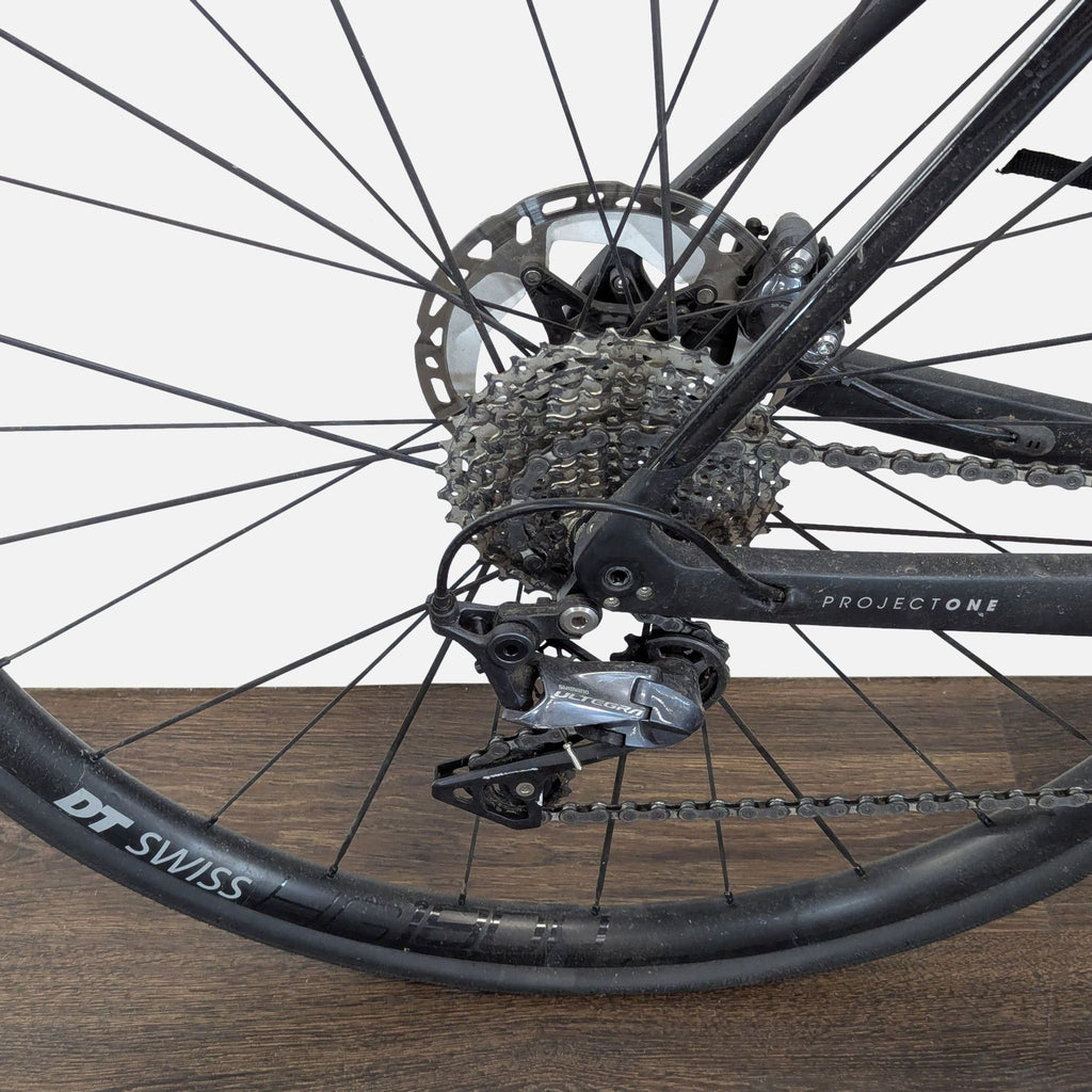 Sleek Trek sports bike in black, equipped with a carbon frame, disc brakes, and storage bag for cyclist gear.