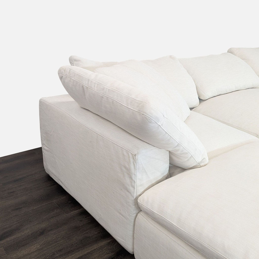 White Restoration Hardware sectional sofa, featuring soft fabric, generous seating, and cozy cushions for comfort.  