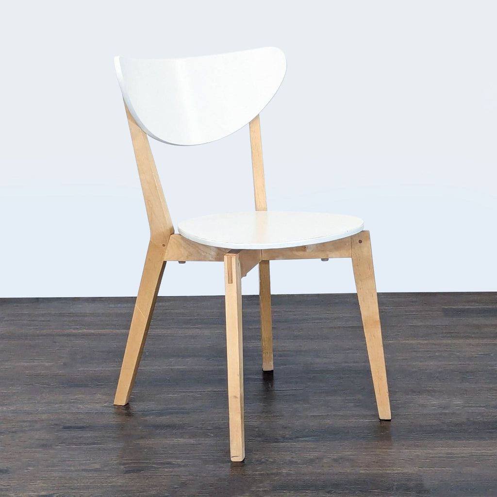 Sleek Ikea chair with white top and wood legs, suitable for dining, kitchen, or office settings.