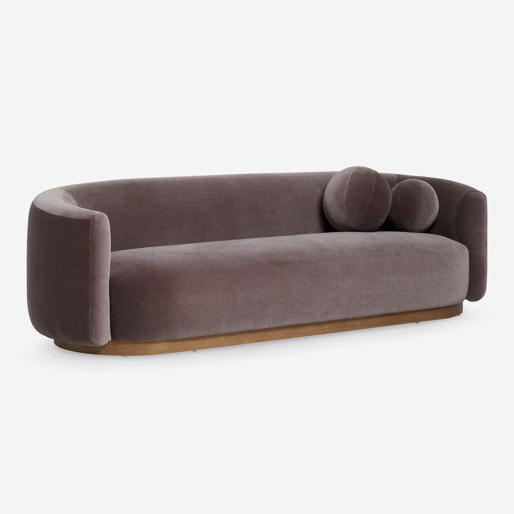 Modern 3-seat sofa by Lulu and Georgia in plush velvet, featuring cozy curves and accent pillows on a wood frame.