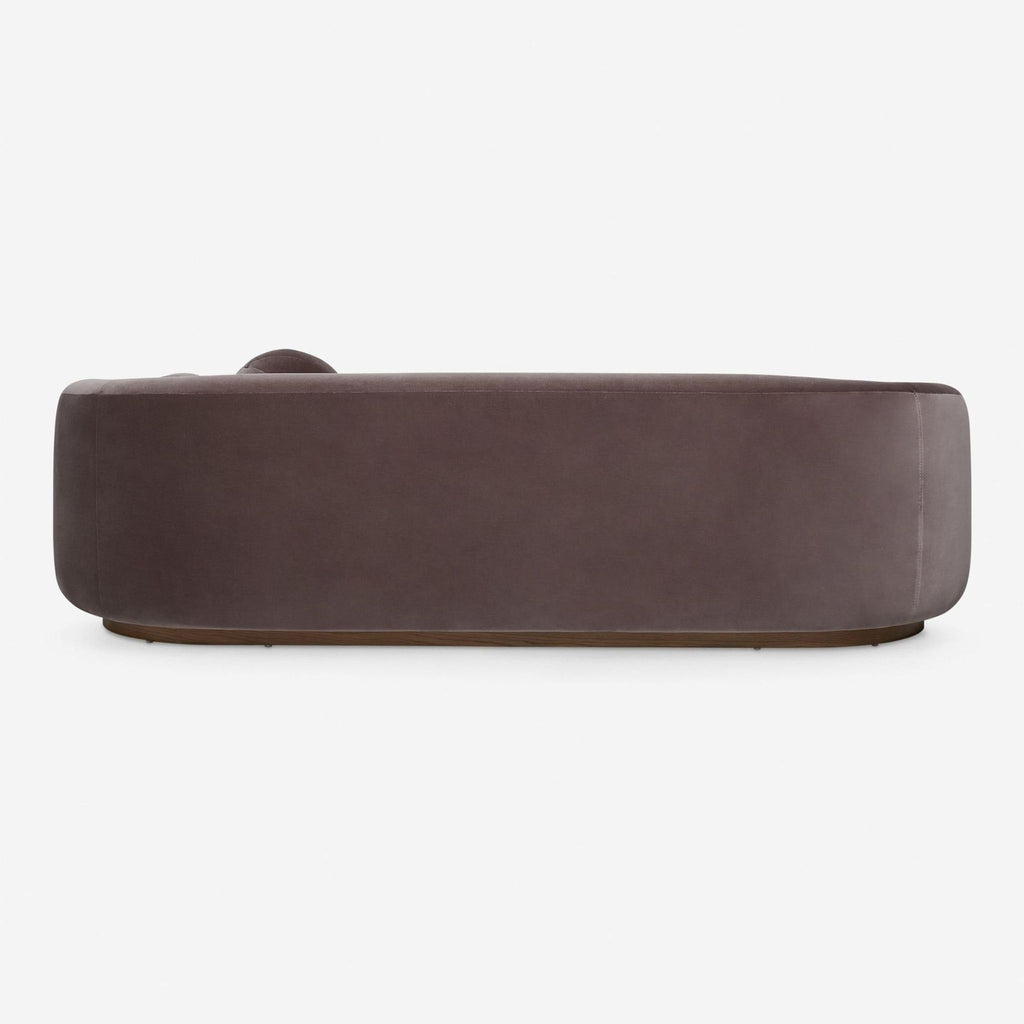 Lulu and Georgia velvet sofa, 3-seater design, sturdy wood base, curved arms, with two round accent cushions.