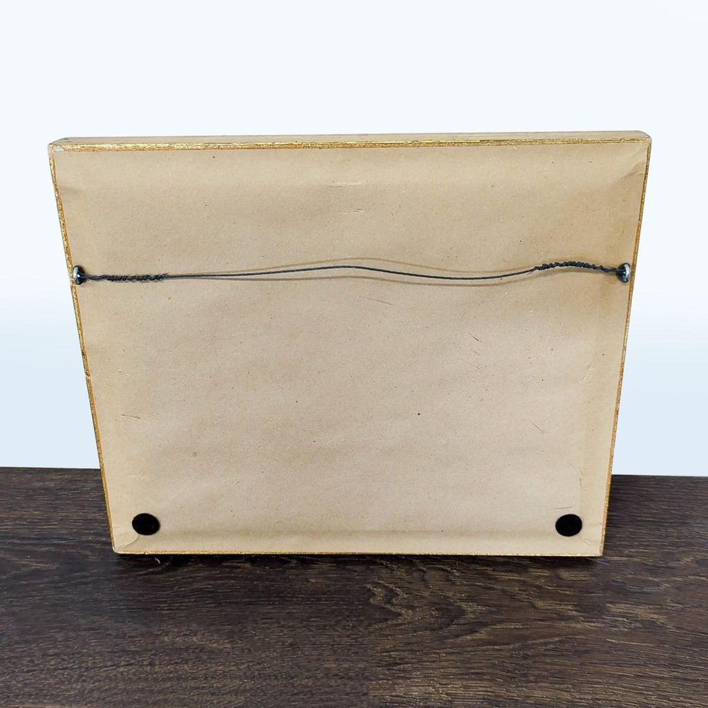 Classic gold-framed painting featuring boats on calm water, soft clouds above, and artist’s signature visible.