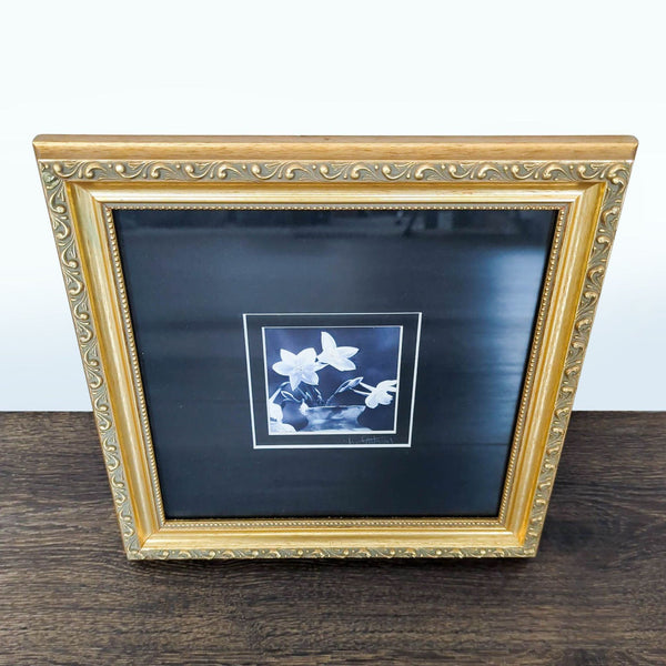 Elegant gold-framed, signed black and white flower print with decorative details, ready to hang.