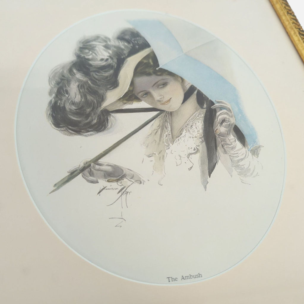 Decorative gold-tone frame displays "The Ambush," featuring a fashionable woman and blue umbrella.  