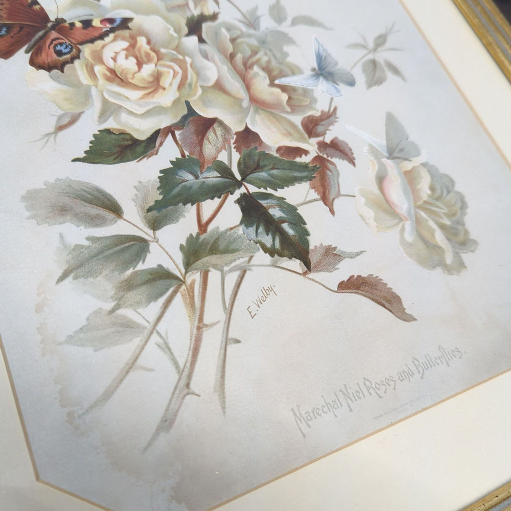 Elegant art print featuring soft yellow roses and colorful butterflies, presented in a gold-toned frame.
