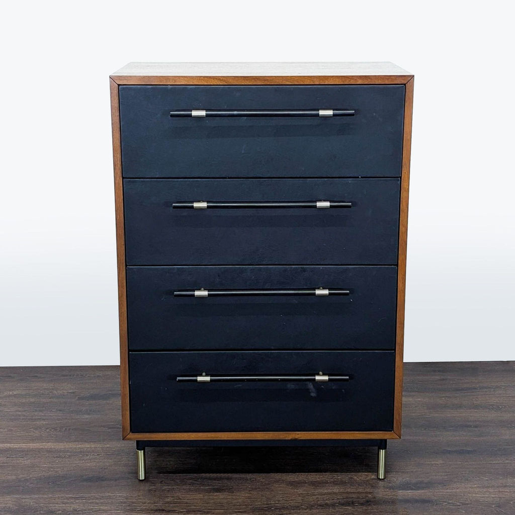 CB2 dresser with four drawers, black faux leather fronts, brass-accented handles, and rich wood frame.