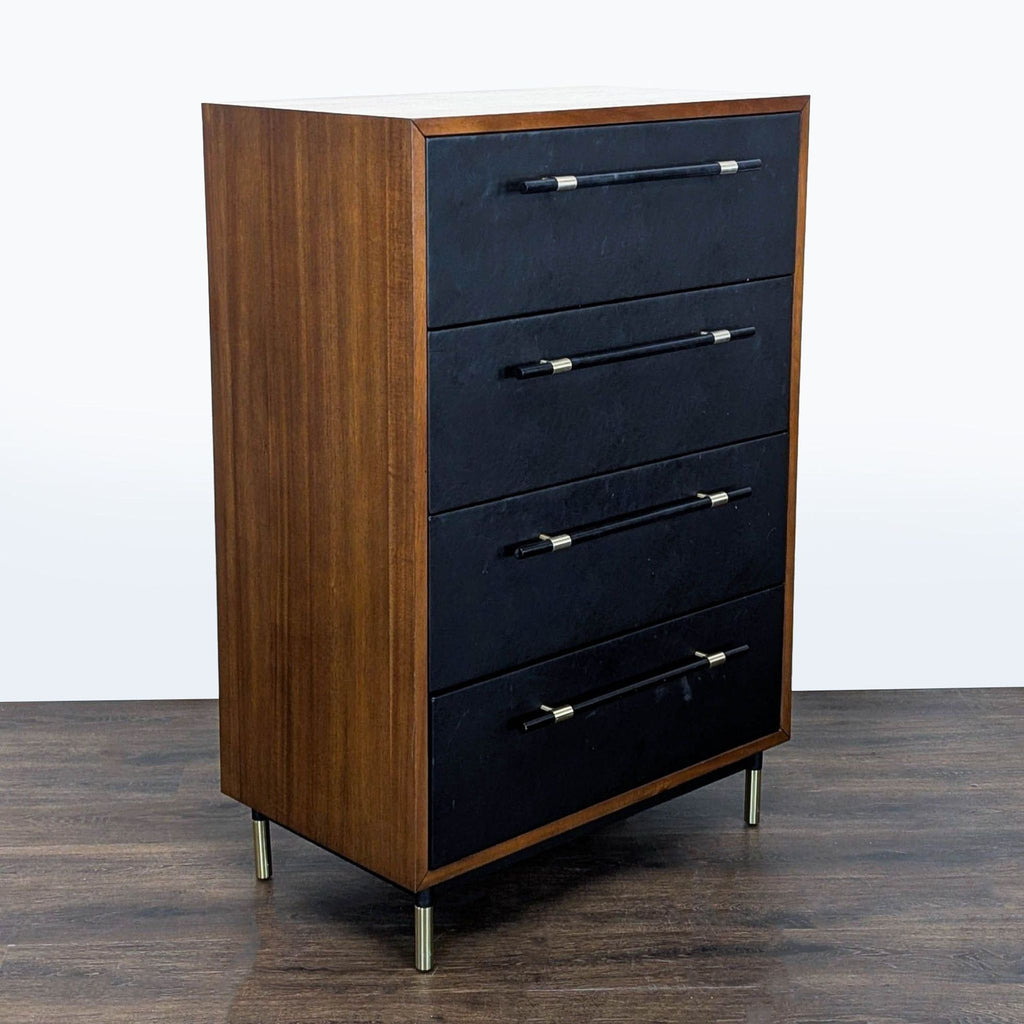 Contemporary CB2 dresser, four drawers with sleek black fronts and stylish brass handles, ideal for modern spaces.