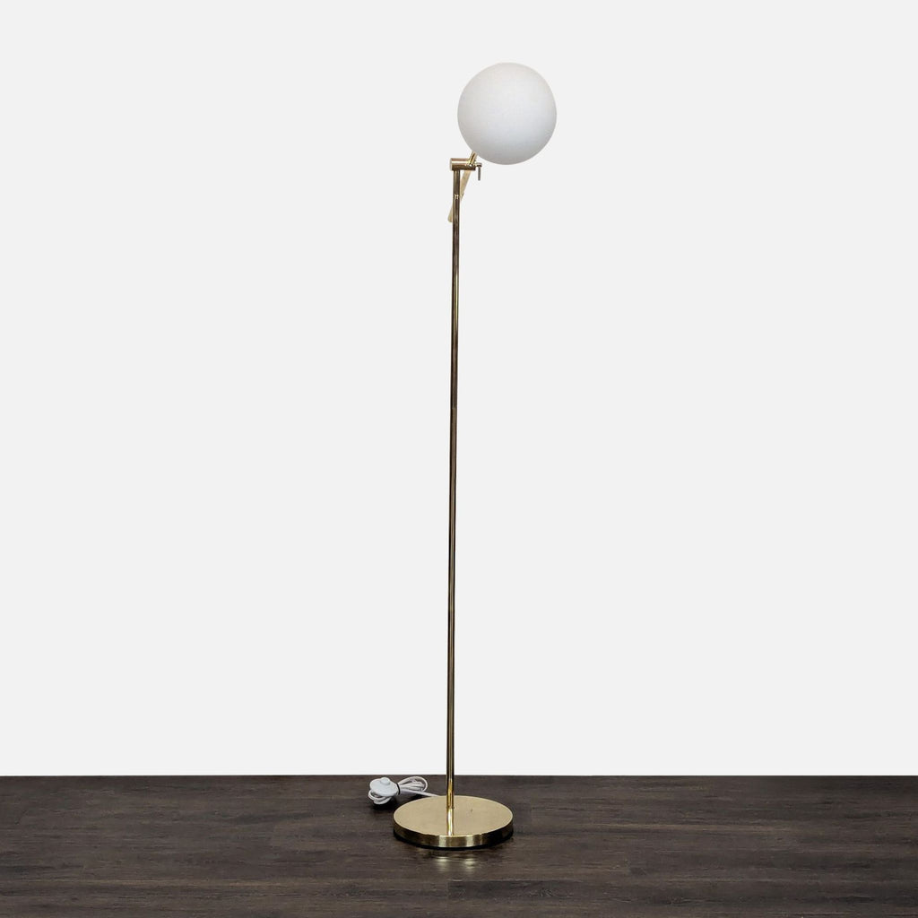 Elegant lighting fixture with brass base, frosted globe shade, and adjustable arm for living spaces.
