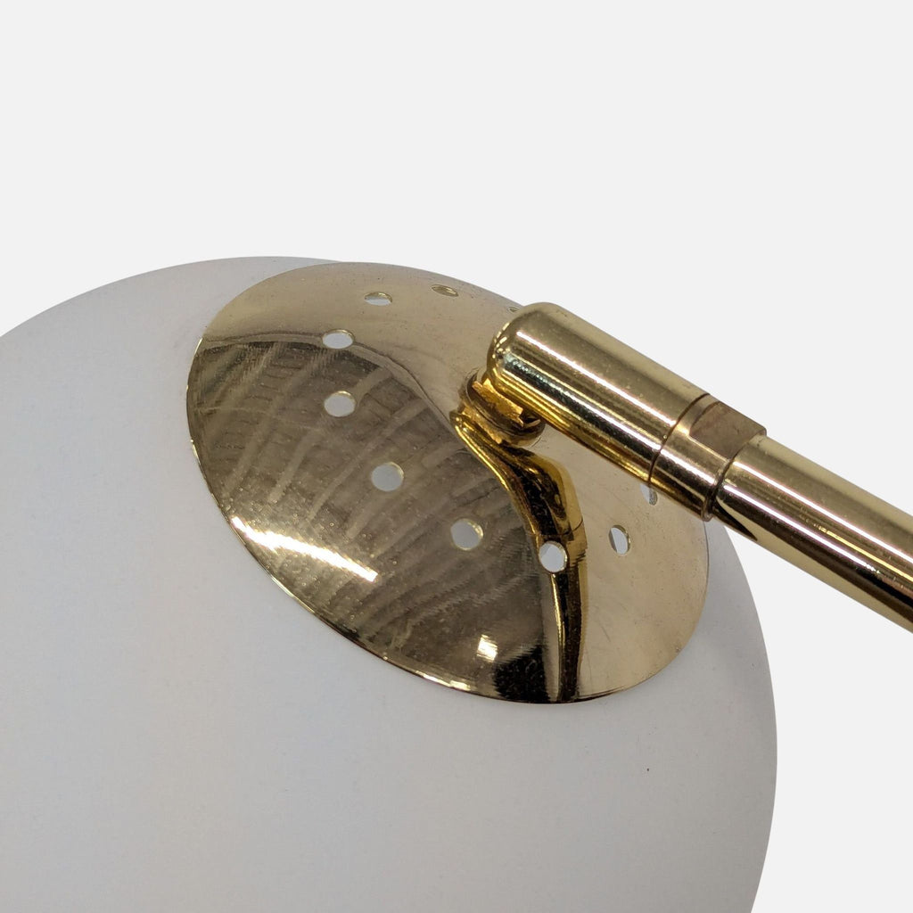 Modern floor lamp featuring a sleek brass finish, globe shade, and adjustable arm for flexible illumination.