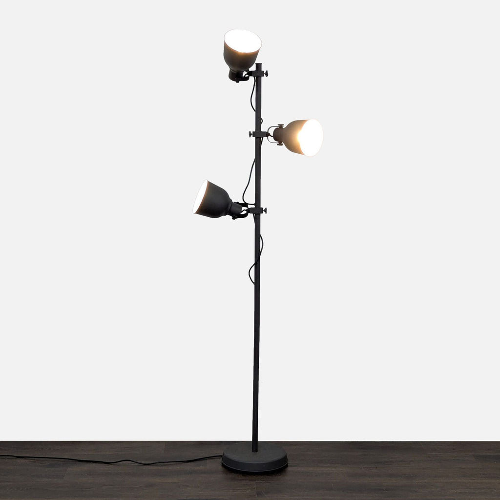 Ikea floor lamp with three adjustable heads and a modern finish, ideal for living rooms or offices.