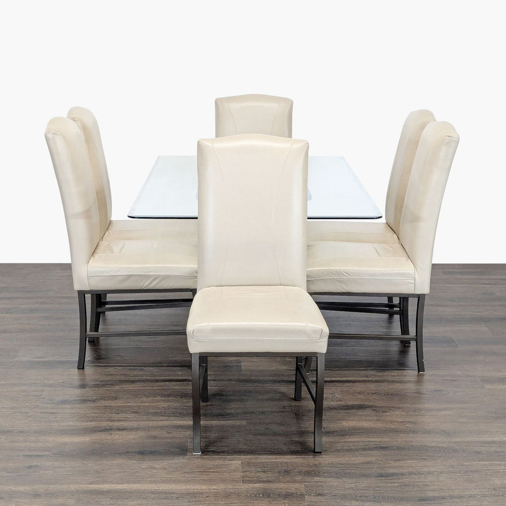 Modern glass dining table and six cream-colored chairs with metal legs from Reflections Furniture.  