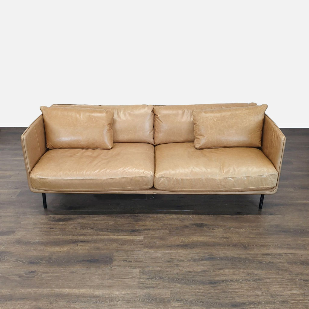 Crate & Barrel 3-seat sofa in tan leather with a boxy modern design and plush cushions.