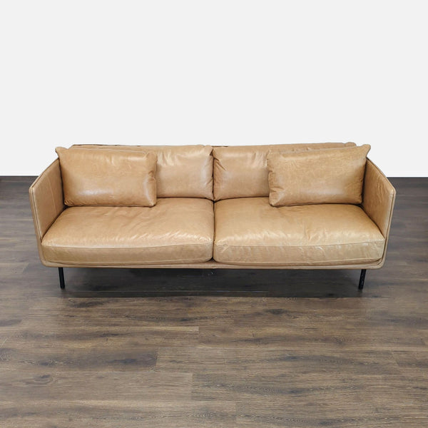 Crate & Barrel 3-seat sofa in tan leather with a boxy modern design and plush cushions.