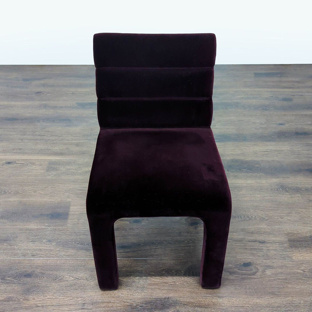 CB2 dining chair upholstered in purple velvet with channel tufting, perfect for modern dining rooms.