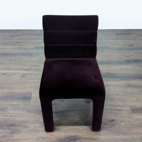 CB2 dining chair upholstered in purple velvet with channel tufting, perfect for modern dining rooms.