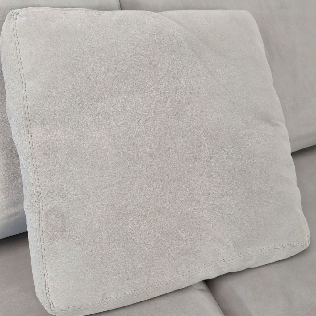 Room and Board sectional in neutral gray, includes chaise, three large back cushions, and two accent pillows.