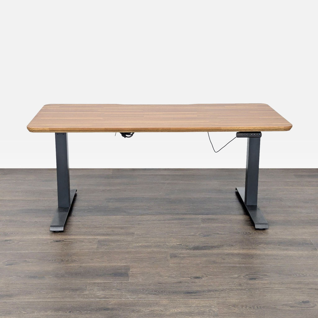Electric Varidesk with height adjustment, black metal legs, and wood finish top for a modern office look.