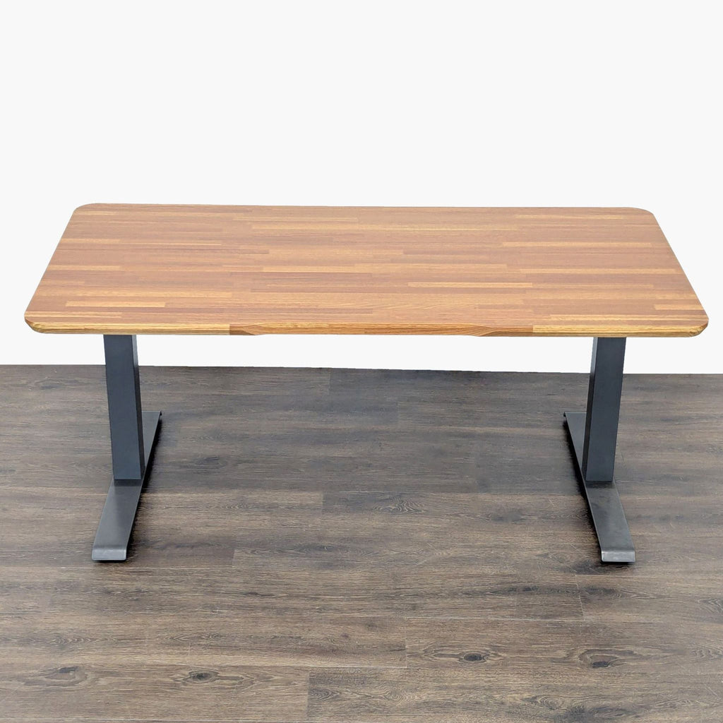 Modern Varidesk adjustable desk, combining a stylish wood top and strong metal legs for flexible workspace use.