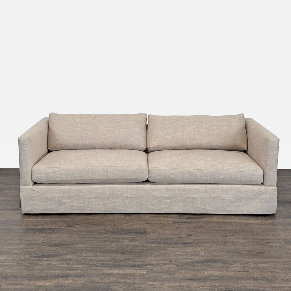 Crate and Barrel loveseat with beige fabric and clean lines, ideal for modern, small living spaces.