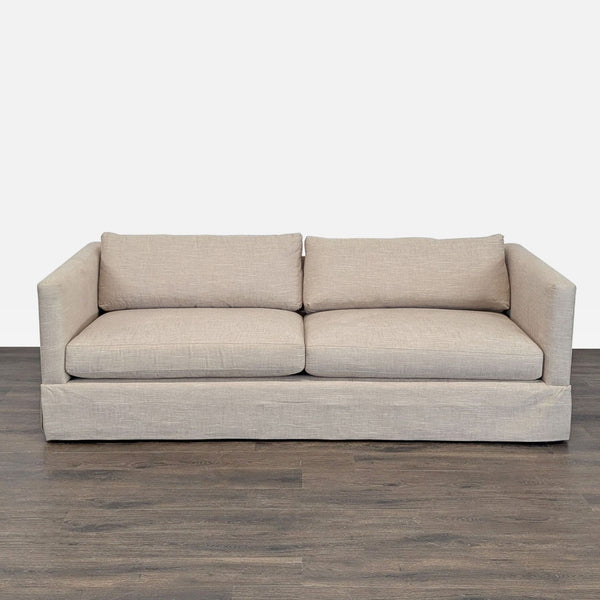 Crate and Barrel loveseat with beige fabric and clean lines, ideal for modern, small living spaces.