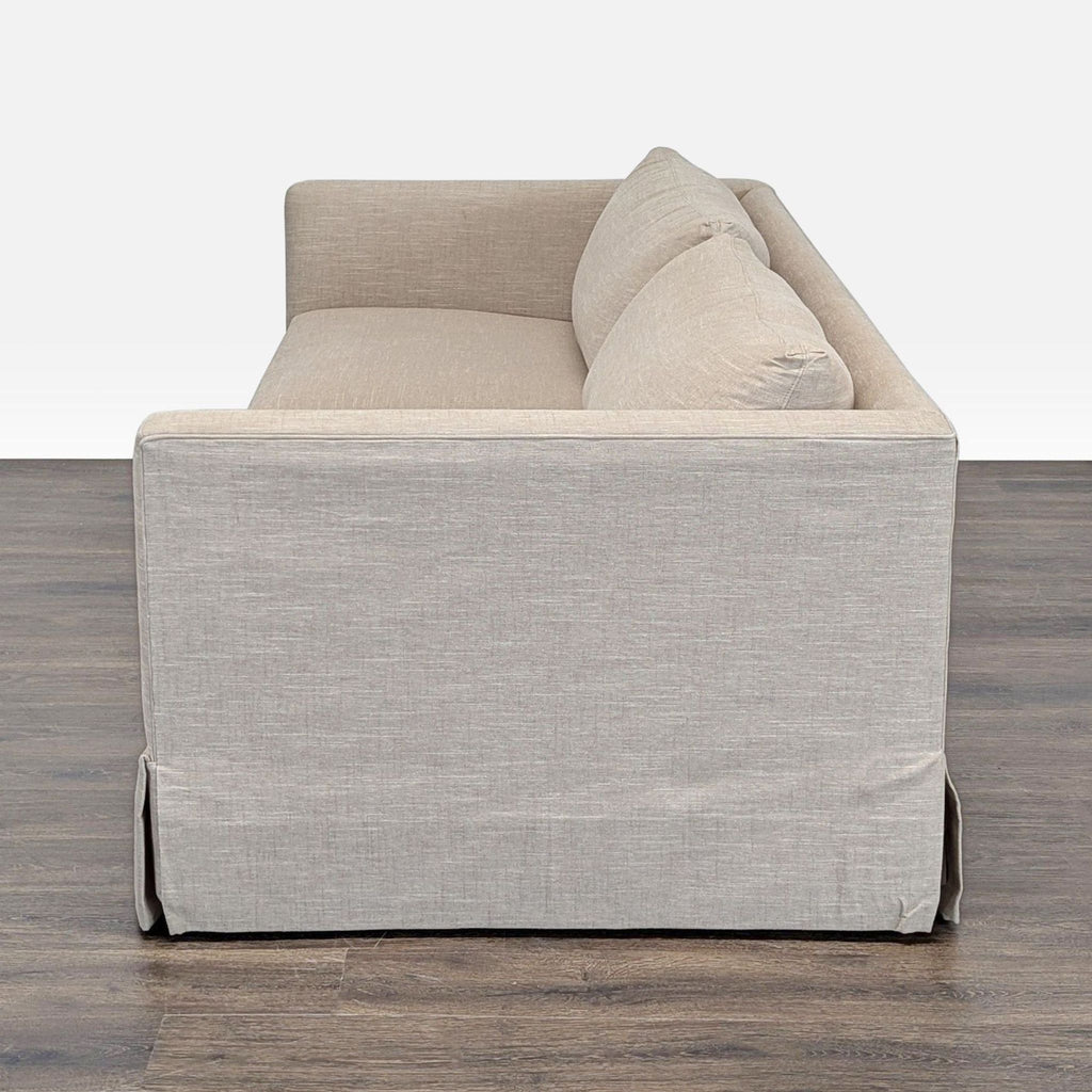 Neutral beige Crate and Barrel loveseat featuring removable seat and back cushions in a modern style.