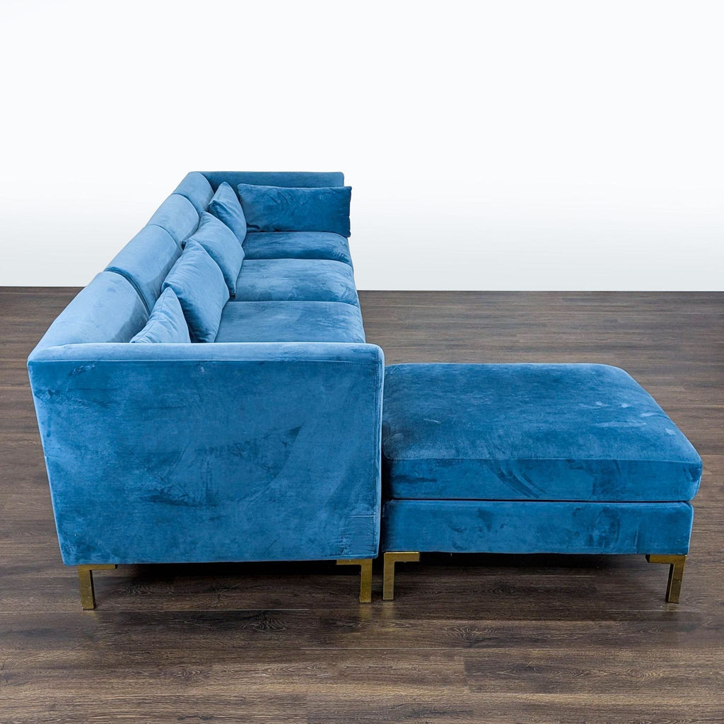 2. Side view of a Chic Home blue velvet sectional highlighting spacious seating and sleek contemporary lines.